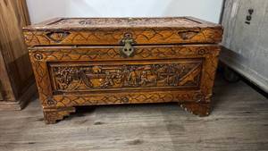 Carved Wood Storage Trunk with Metal Hardware and Decorative Relief Panels