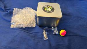 lot 146 image: Puffing Bird Concentrating Clear Glass Angled Banger with Tin Case and Silicone Container