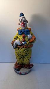 lot 187 image: Painted Clown Figurine Holding Duck, Standing on Round Base