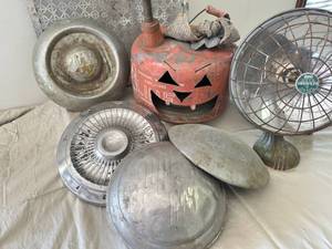 lot 26 image: Hubcaps, antique heater and gas can jack-o-lantern