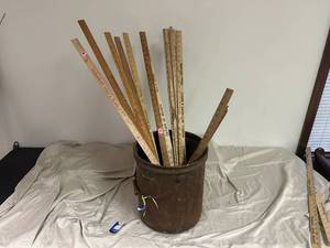 lot 86 image: Bucket with 12 yardsticks