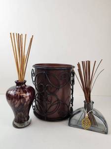 lot 204 image: Reed Diffuser Lot 2 Bottles with Reeds and Scrolled Brown Holder
