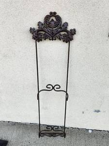 lot 217 image: Tall Dark Brown Metal Wall Rack with Ornate Leaf Top and Two Scroll Cradles