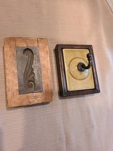 lot 1007 image: Antique wooden printing block featuring scroll-like design, plus a ceramic tile wall hook