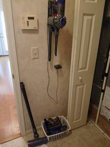 lot 1100 image: Dyson V6 Absolute Stick Vacuum with Attachments,  Works, Buyer bring tools to remove from wall, phillipshead Screwdriver