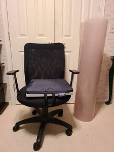 lot 1214 image: Rolled up plastic office chair mat and office chair, plus pressure reduction 2in gelfoam cushion
