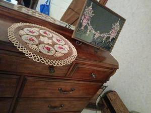 lot 1422 image: Framed Embroidery Wall Art with Pink Urns and Floral Garland 13x17.5, with embroidered table decor 18 inch diameter