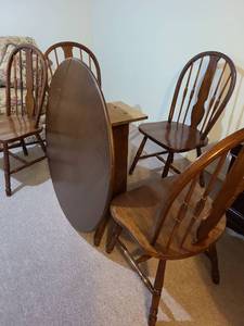lot 2003 image: Round drop sides table, 30x40in round sides up. 30x 26in with both sides down, by Ashley Furniture, located in garage loft. Already disassembled.