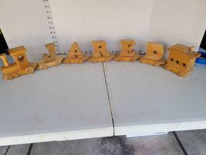 lot 3233 image: Handmade wooden train spelling out J A R E D, 37in long