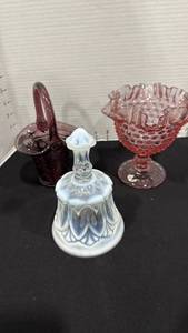 lot 1027 image: Fenton Amethyst Purple Glass Basket, Fenton pink or cranberry opalescent glass compote or pedestal bowl,  Fenton Art Glass Whitton pattern bell in a blue or aqua opalescent