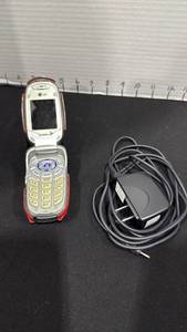 lot 1040 image: LG flip phone with adapter