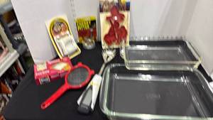 lot 1054 image: Fire King and Pyrex baking pans, cherry pitter and egg slicer new, spoons and more