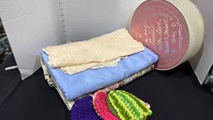 lot 1069 image: Tablecloths, table runner, crochet glass socks and hat box