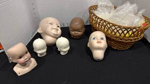lot 1074 image: Doll heads with a basket