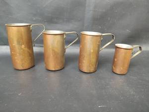 lot 24 image: Vintage Copper Measuring Cup Set, 1, 34, 12 and 14 Cups