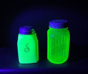 lot 97 image: Uranium Glass Shakers White with Green S Script and Green Ribbed with Metal Top