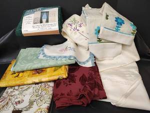 lot 550 image: Assorted Table Linens, Embroidered Pillowcase and Doily, Plastic Tablecloths and Window Panel Set 60x81