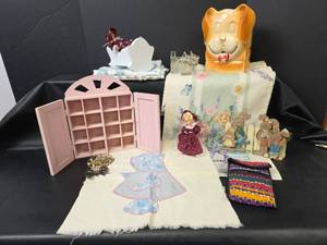lot 563 image: Pink Wall Display Cabinet, Dolls, Dog Figurines, and Linens