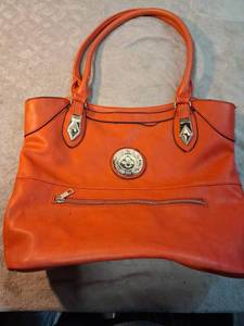 lot 16 image: Red Tote Bag with Medallion Detail and Dual Handles