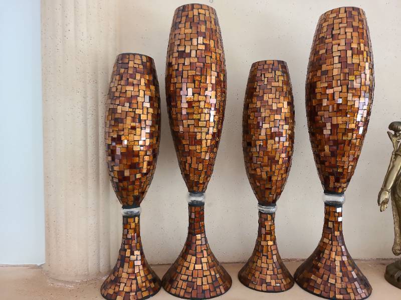 lot 1002 image: Four amber-toned mosaic glass candle holders, 18in and 23in tall