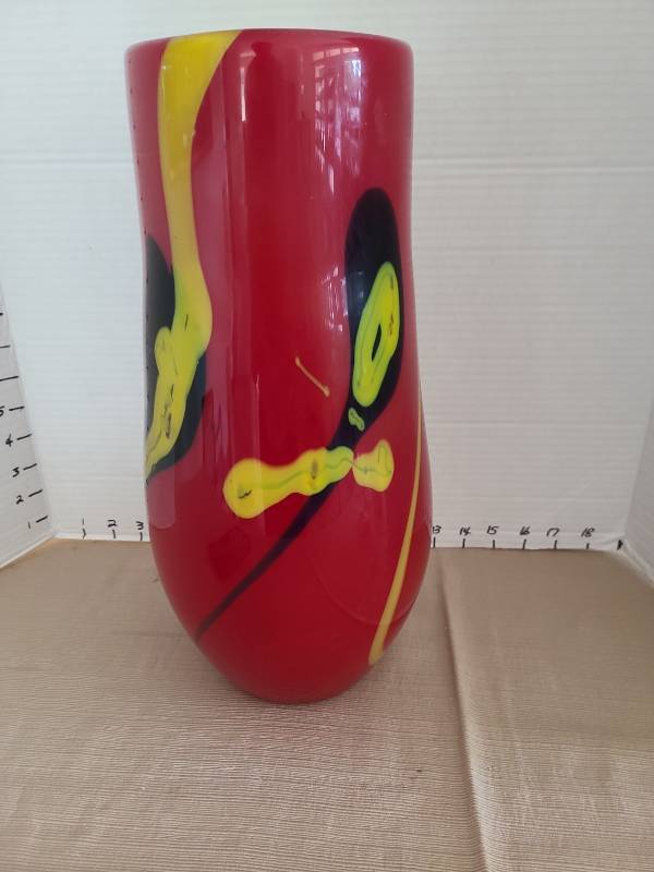 lot 1015 image: Red hand blown art glass vase with yellow and black swirl pattern