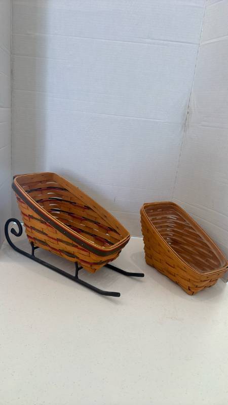 lot 1103 image: Longaberger 1997 Holiday Sleigh Basket with iron sleigh base and Longaberger Small Vegetable Basket