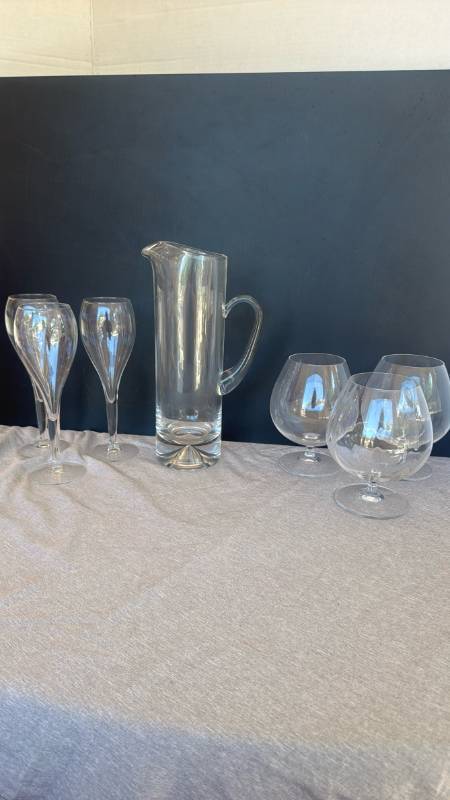 lot 1253 image: 3 clear brandy snifter  cognac balloon glasses, tulip-shaped champagne flutes and pitcher