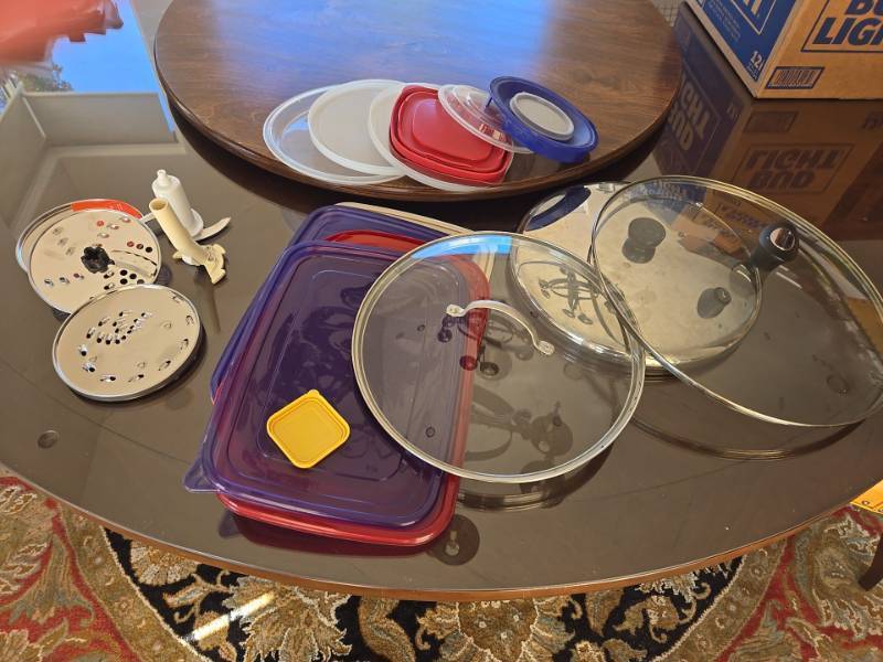 lot 1295 image: Box of Cuisinart Food Processor blades, skillet lids and kitchen storage lids