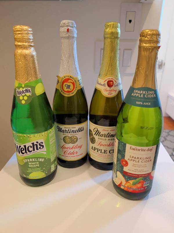 lot 1338 image: Lot of 4 Sparkling Juice Bottles Welchs, Martinellis, Favorite Day 750ml