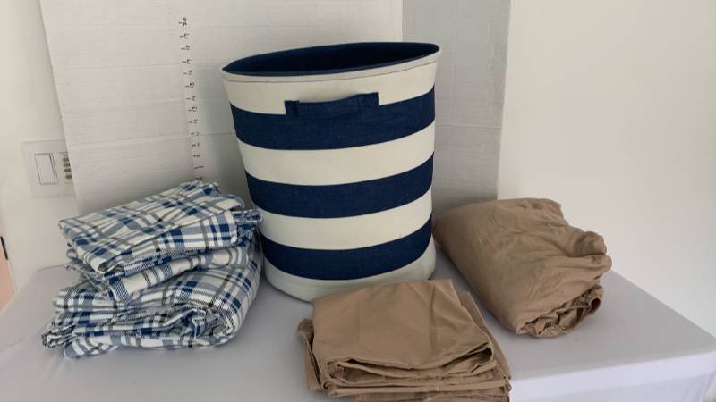 lot 1400 image: King misc sheets and pillow cases with hamper