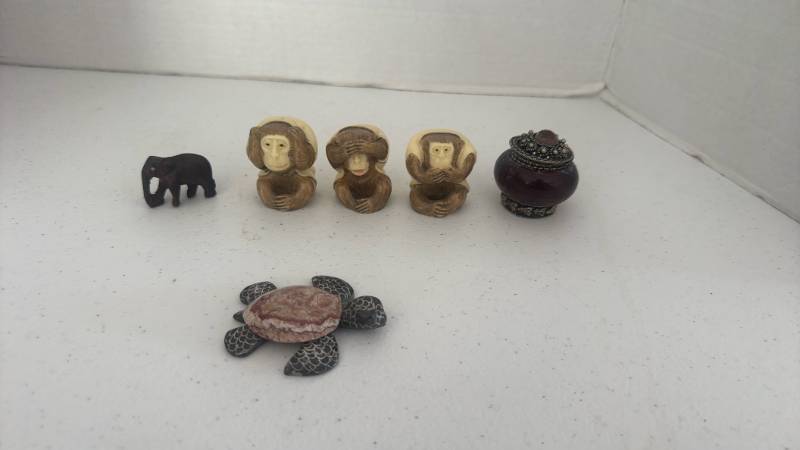 lot 1511 image: Three Wise Monkeys figurines representing hear no evil, see no evil, and speak no evil, small carved elephant, and more all about 2 inches tall