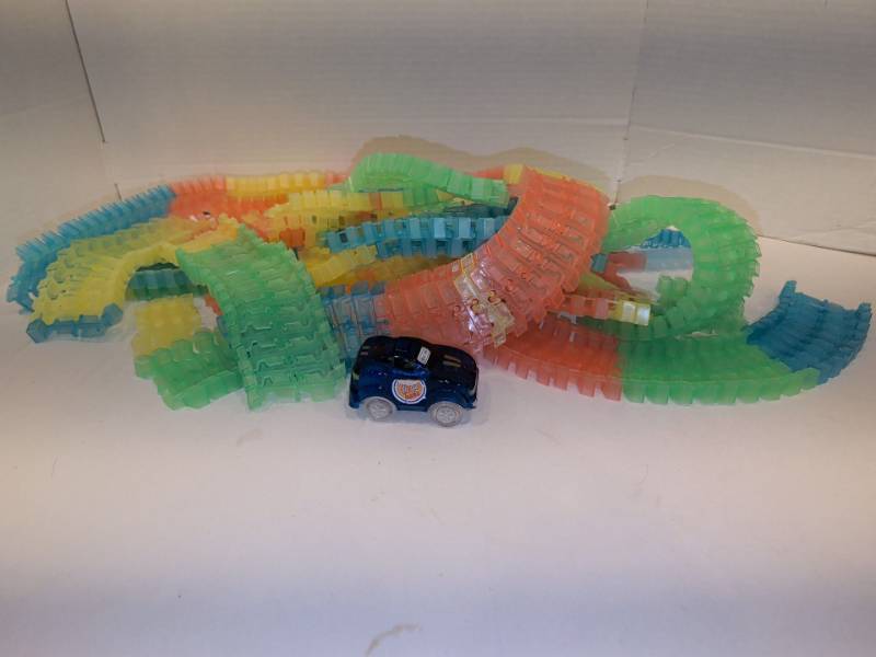 lot 2218 image: Magic Tracks Flexible Plastic Race Track Set with Blue Toy Race Car, Multicolor Pieces