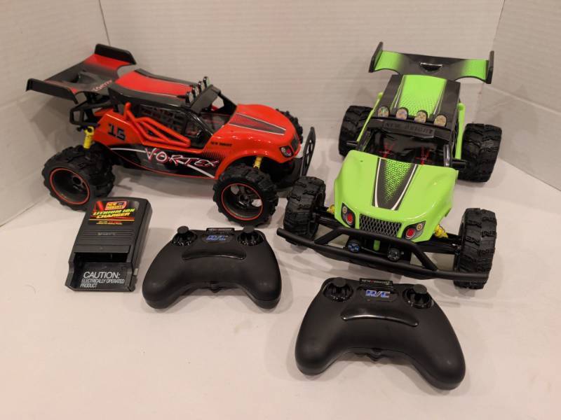 lot 2227 image: New Bright Vortex RC Buggy Lot of 2 with 2 Remote Controls and Charger