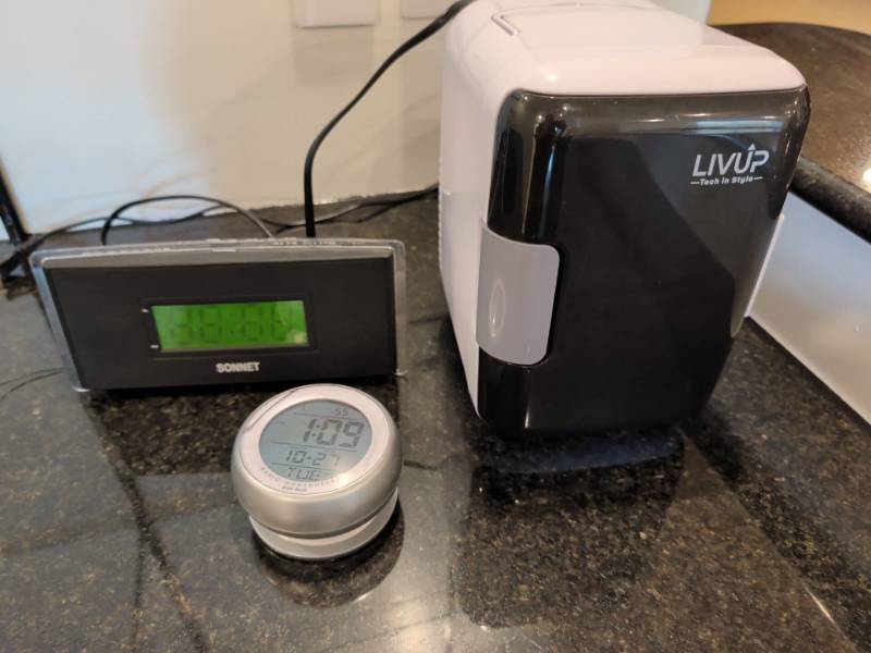lot 2282 image: LIVUP Portable Mini Fridge and clocks