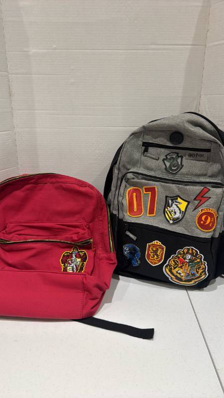 lot 2386 image: Harry Potter Backpack Lot of 2 with Hogwarts House Crest Patches
