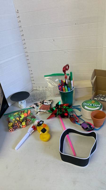 lot 3080 image: Pens, duct tape, magnets, skull candle holder , pinwheel and more