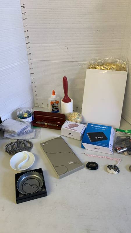 lot 3081 image: Misc lot of PayPal chip trader, magnets, IPhone 14 Pro case, bag sealer and more