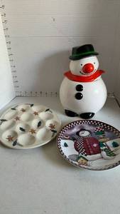 lot 3469 image: Snowman cookie Jar, Gingerbread Holly Deviled Egg Plate and Snowed Inn Plate