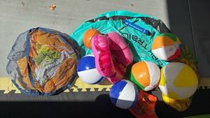 lot 4131 image: Inflatable Beach Ball and Pool Toy Lot with Pump and Mesh Bag