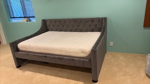 lot 27 image: Queen size daybed with gray, upholstery and silver nail heads 42 x 84 x 58 located in basement