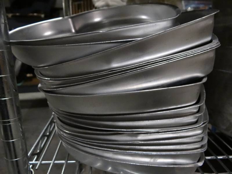 lot 9335 image: Contents of Shelf Heart Shape Cake Molds, Stack of Skillets, Stock Pots, Large Sauce Pans, Large Bundt Pans, Stack of New Cornstick Pan Molds