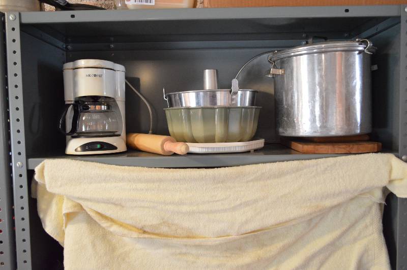 lot 1356 image: All on shelf - coffee maker, bundt pan, rolling pin, pot, and more