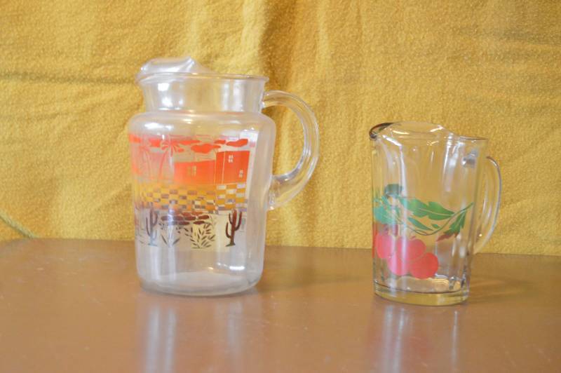 lot 1502 image: Two tea pitchers - glass - cute design