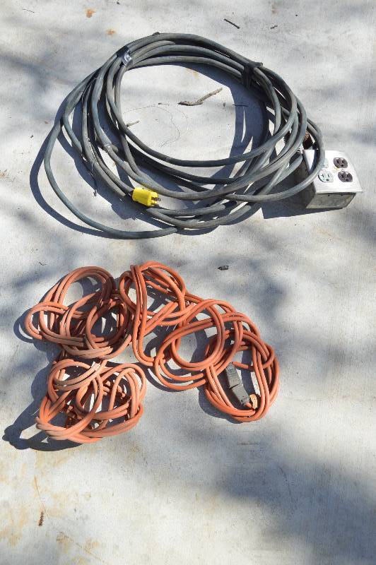 lot 1966 image: Black extension cord with 4 outlet box and orange extension cord
