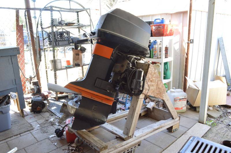 lot 1163B image: Boat Motor on stand with fuel tank and parts