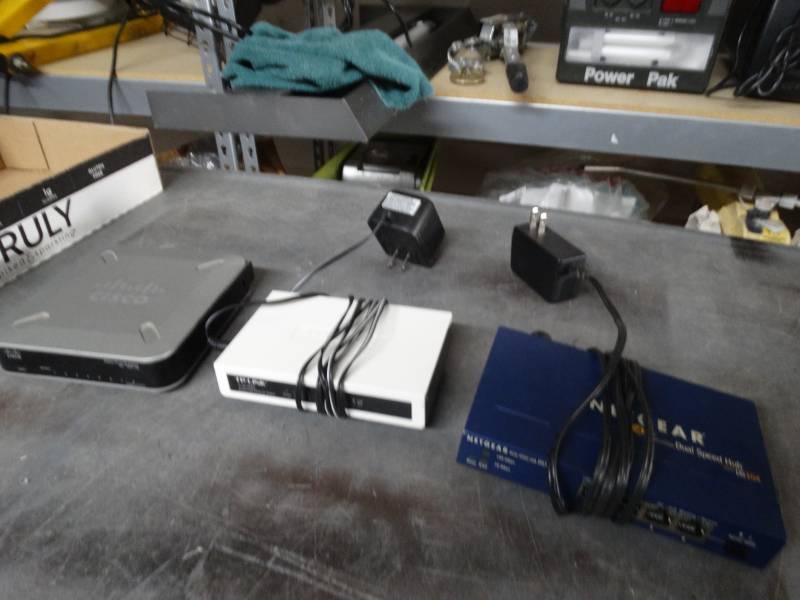 lot 8398 image: Tp-link 8 port fast ethernet switch, netgear dual speed hub and cisco gigabit switch.