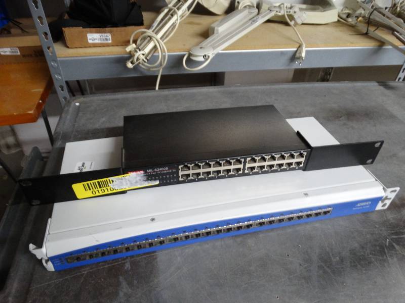 lot 8423 image: Milan mil-S2400S 24 port 10100base-TX and Adtran netvanta 1224R.