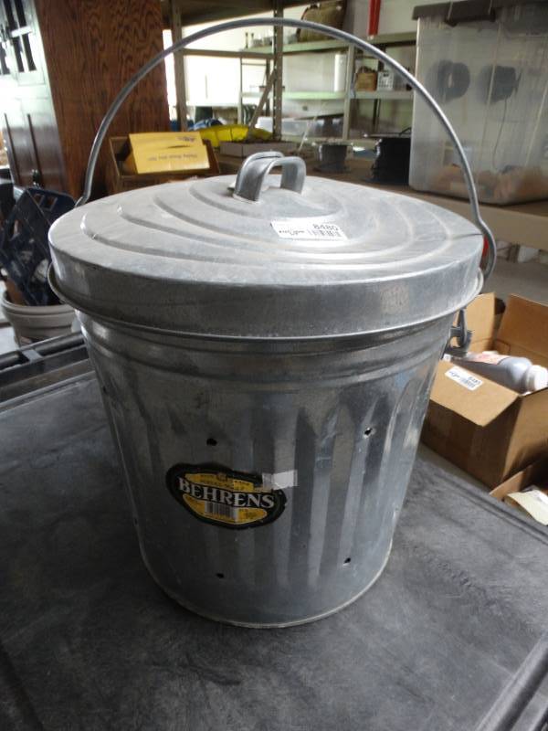 lot 8480 image: Small metal trash can wholes in it.