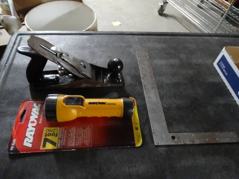 lot 8550 image: New Rayovac flashlight and wood plane.