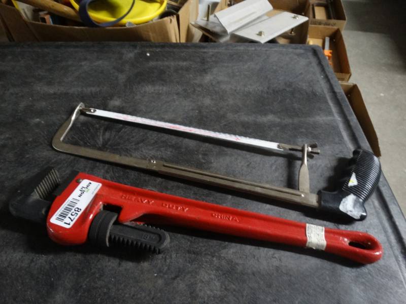 lot 8571 image: mintcraft Pipe wrench 18 and a hand saw.